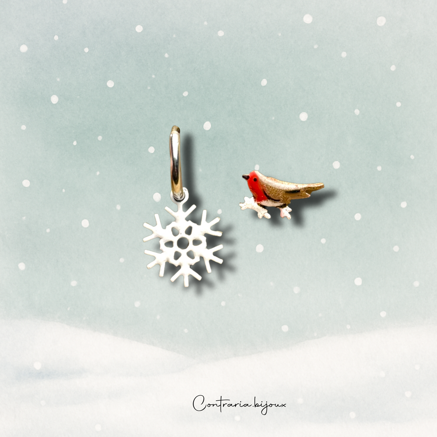 Orecchini pettirosso sulla neve  e fiocco di neve pendente